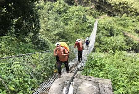 Notre guide à la sortie d&#039;un pont suspendu en direction de Jagat